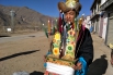 A young man in Lhasa holds his chemar box, an auspicious item to pray for good harvests, to greet visitors on February 26.jpg