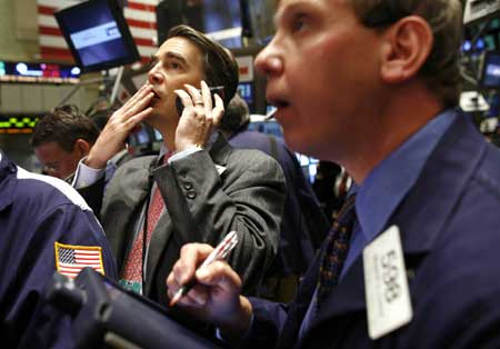 Traders work on the floor of the New York Stock Exchange April 20, 2009. Wall Street tumbled Monday after a six-week rally with all major indexes dropping more than 3 percent on financial concerns.