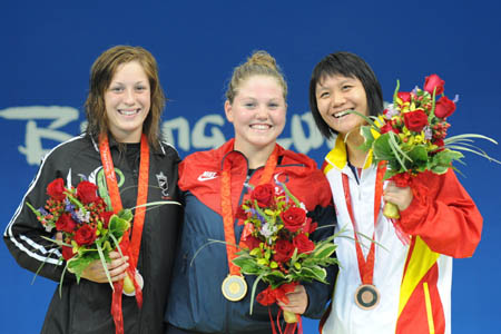 Gold medalist Anna Eames (C) of the United States, silver medalist Sophie Pascoe of New Zealand and bronze medalist Wang Shuai of China pose on the podium during the awarding ceremony of the S10 final of women&apos;s 100m butterfly of the Beijing 2008 Paralympic Games at the National Aquatics Center in Beijing, Sept. 8, 2008. (Xinhua/Yang Shiyao) 