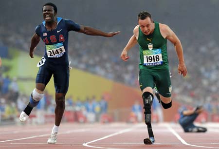 "Blade Runner" Oscar Pistorius (R) from South Africa crosses the finish line ahead of Jerome Singleton of the United States during the final of men