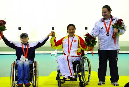 Gold medalist Lin Haiyan(C) of China, silver medalist Moon Aee-kyung(L) of South Korea and bronze medalist Natalia Dalekova of Russia react at the awarding ceremony for the women&apos;s P2-10m air pistol SH1 of shooting event during Beijing 2008 Paralympic Games in Beijing, Sept. 8, 2008. 