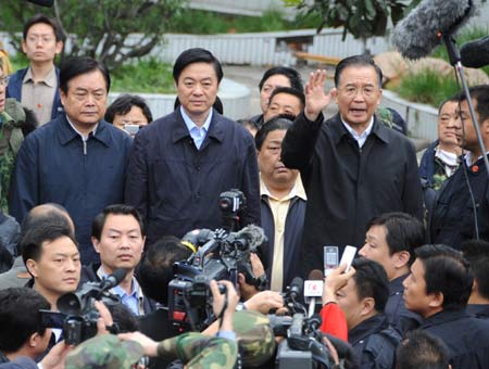 Chinese Premier Wen Jiabao speaks to rescue workers at the Beichuan middle school in Beichuan County, which neighbors the epicenter of the Monday's 7.8 magnitude earthquake, southwest China's Sichuan Province, May 14, 2008. Wen arrived at Beichuan to oversee the rescue work in Sichuan Province. (Xinhua Photo) Chinese Premier Wen Jiabao speaks to rescue workers at the Beichuan middle school in Beichuan County, which neighbors the epicenter of the Monday's 7.8 magnitude earthquake, southwest China's Sichuan Province, May 14, 2008. Wen arrived at Beichuan to oversee the rescue work in Sichuan Province. (Xinhua Photo)