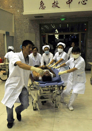 An injured man is carried to an urgent care center in Urumqi, capital of northwest China&apos;s Xinjiang Uygur Autonomous Region on July 5, 2009.